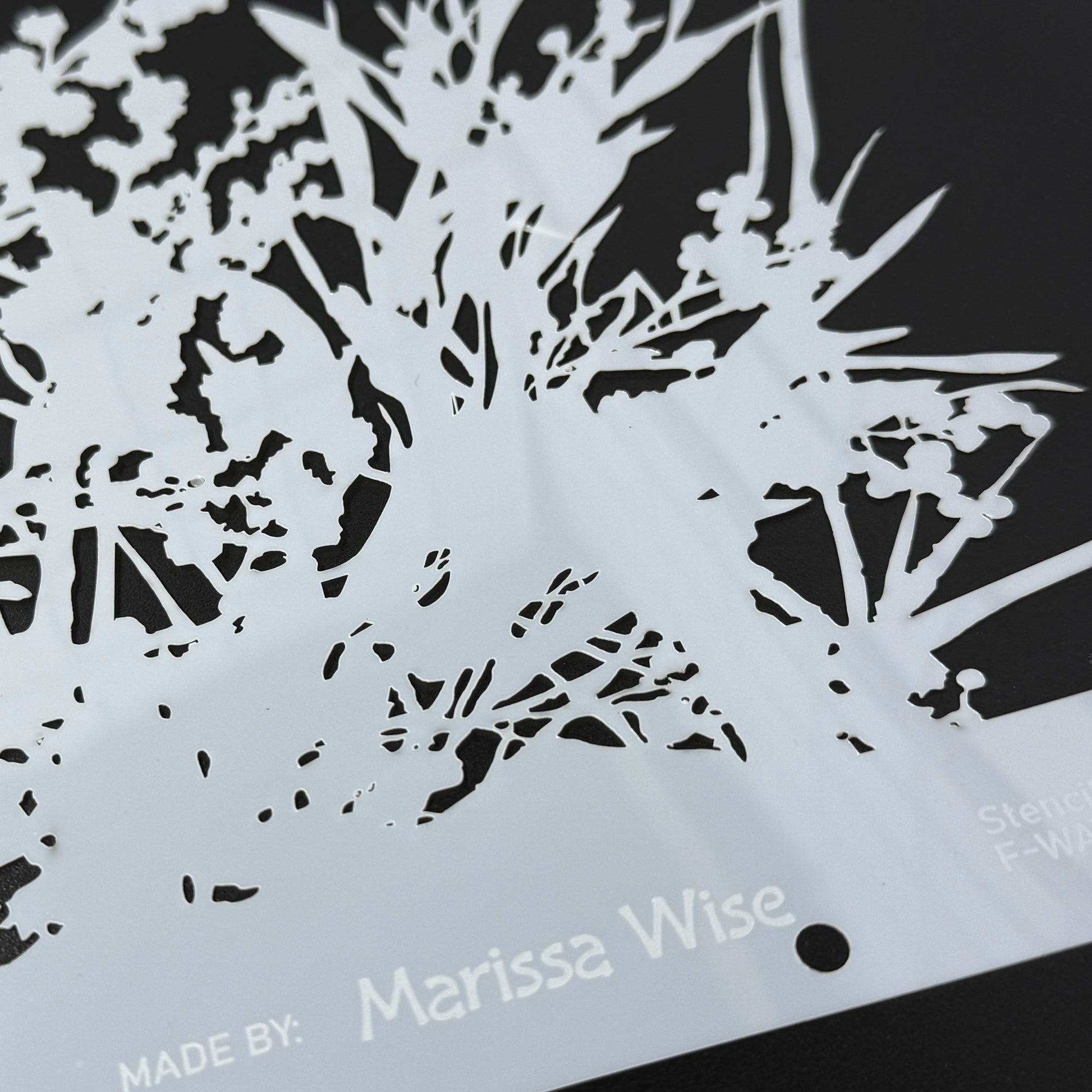 Stylized cutout of plants with 'Made by Marissa Wise' text on a black background