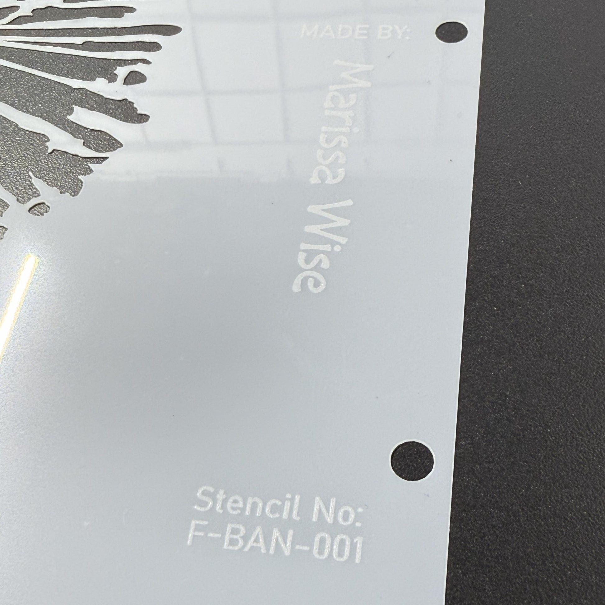 Clear stencil with 'Marissa Wise' branding on a dark surface